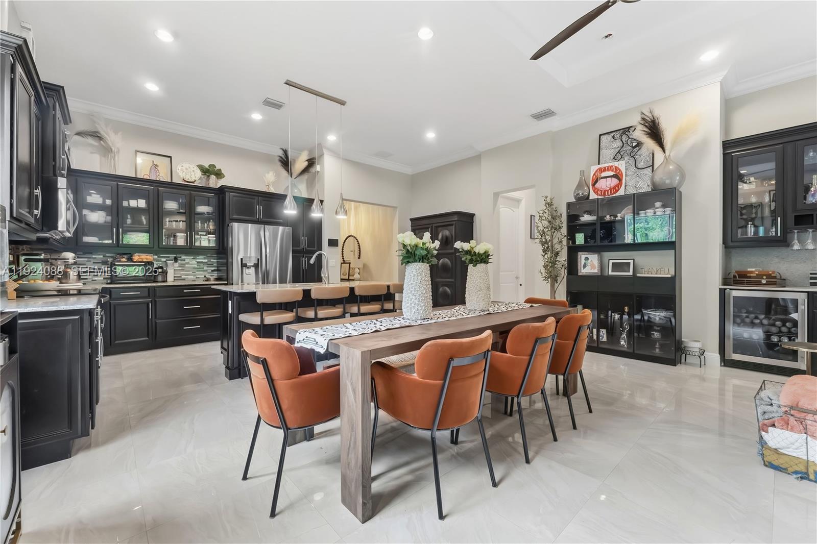 14929 Southwest 176th Terrace Miami, FL 33187 - Photo 12 of 38 a large kitchen with a table and chairs
