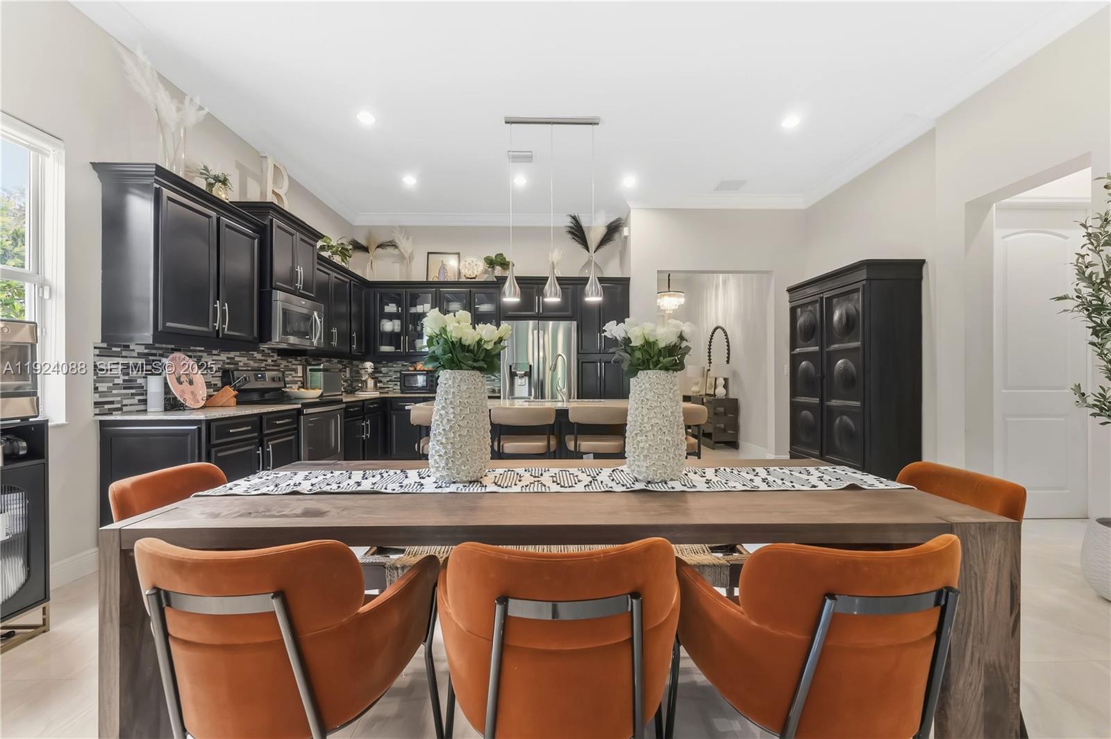 14929 Southwest 176th Terrace Miami, FL 33187 - Photo 13 of 38 a kitchen with stainless steel appliances kitchen island granite countertop a sink and cabinets