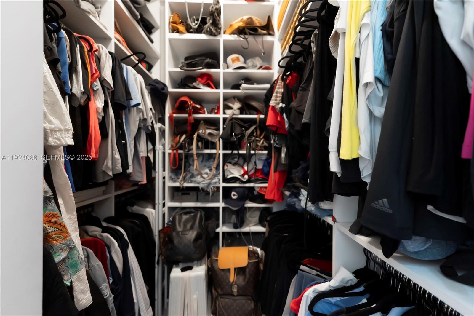 14929 Southwest 176th Terrace Miami, FL 33187 - Photo 16 of 38 a view of walk in closet with clothes and shoes
