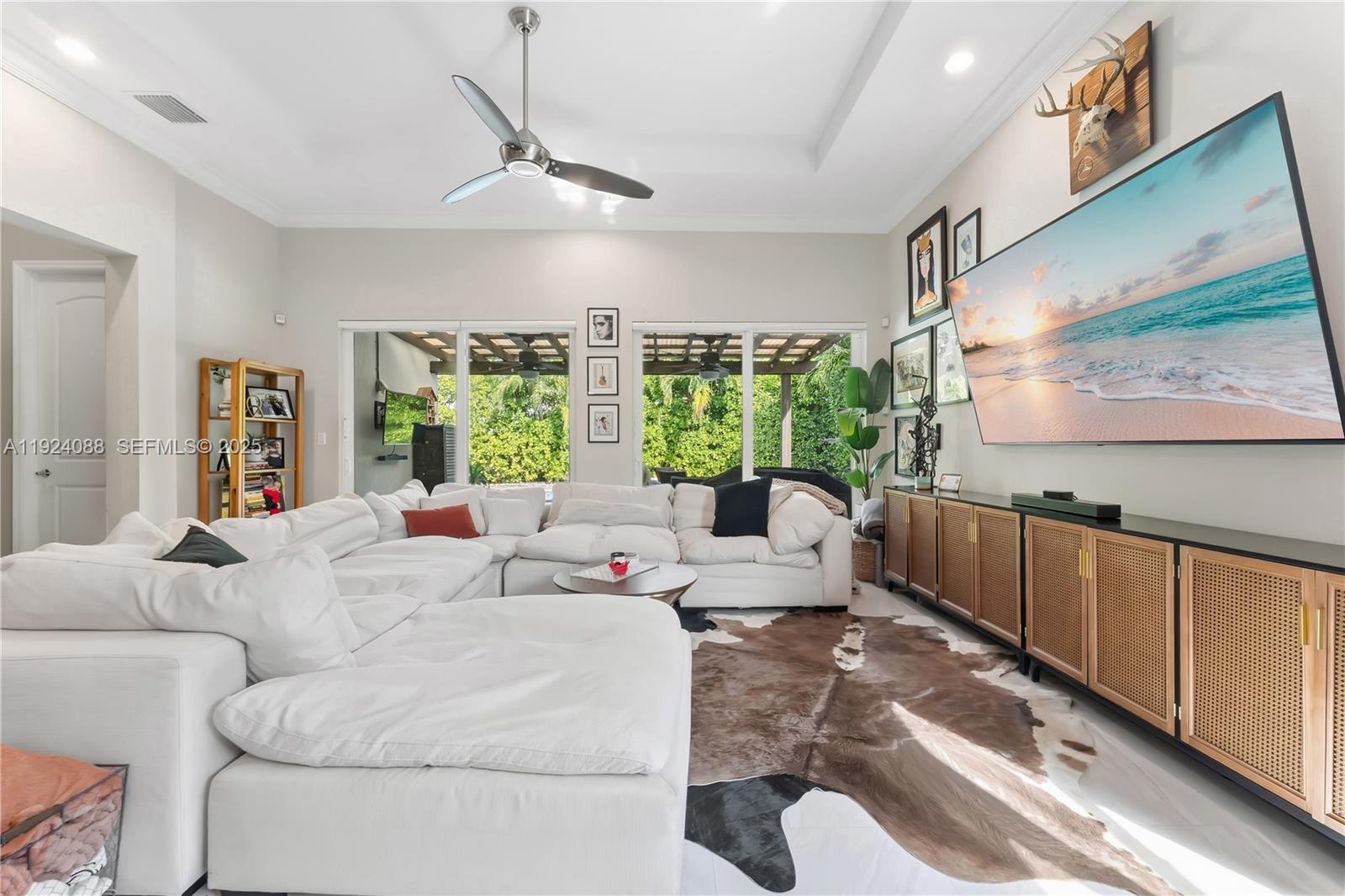 14929 Southwest 176th Terrace Miami, FL 33187 - Photo 2 of 38 a living room with furniture and a large window
