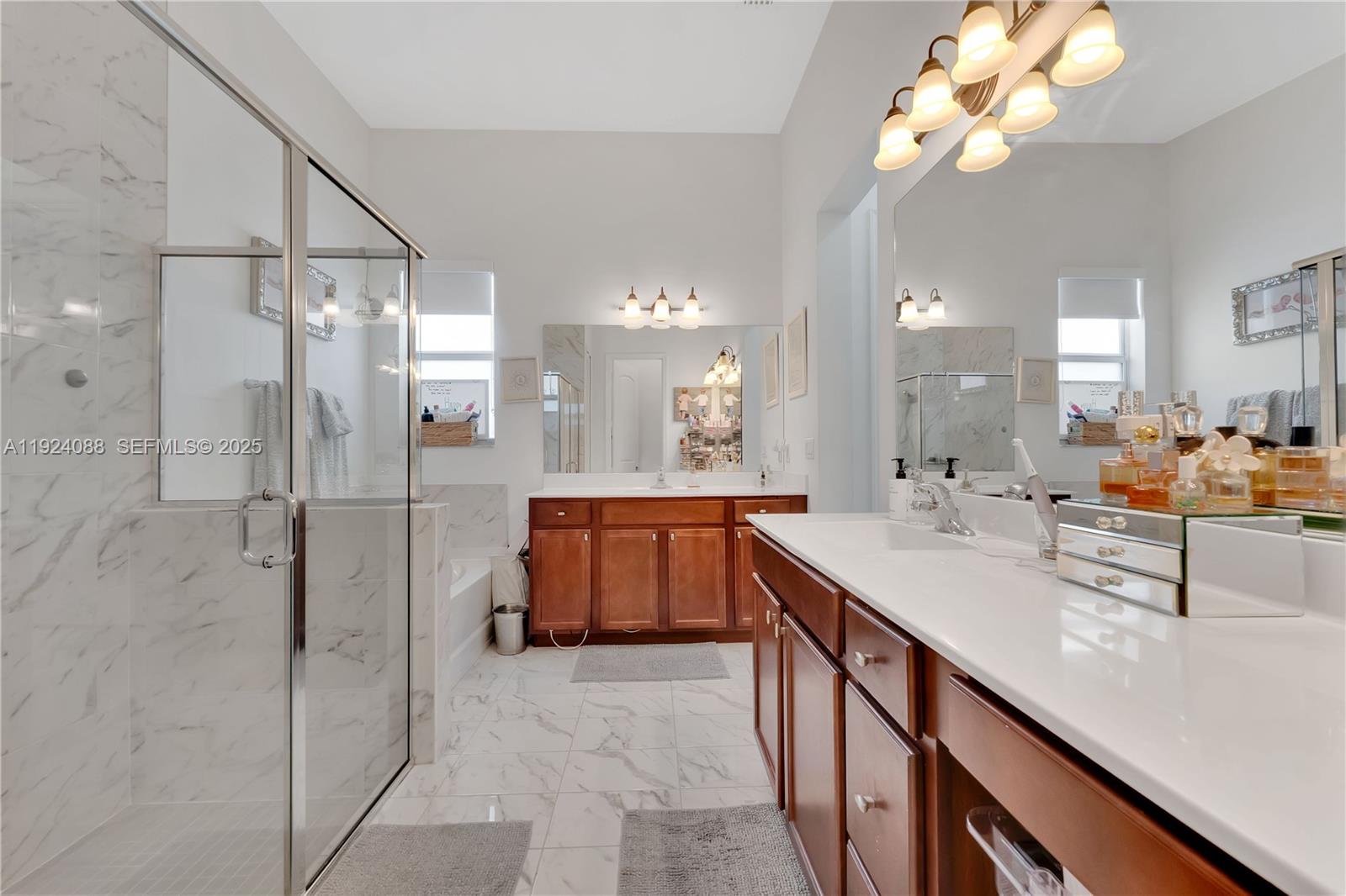 14929 Southwest 176th Terrace Miami, FL 33187 - Photo 21 of 38 a bathroom with a double vanity sink mirror and shower