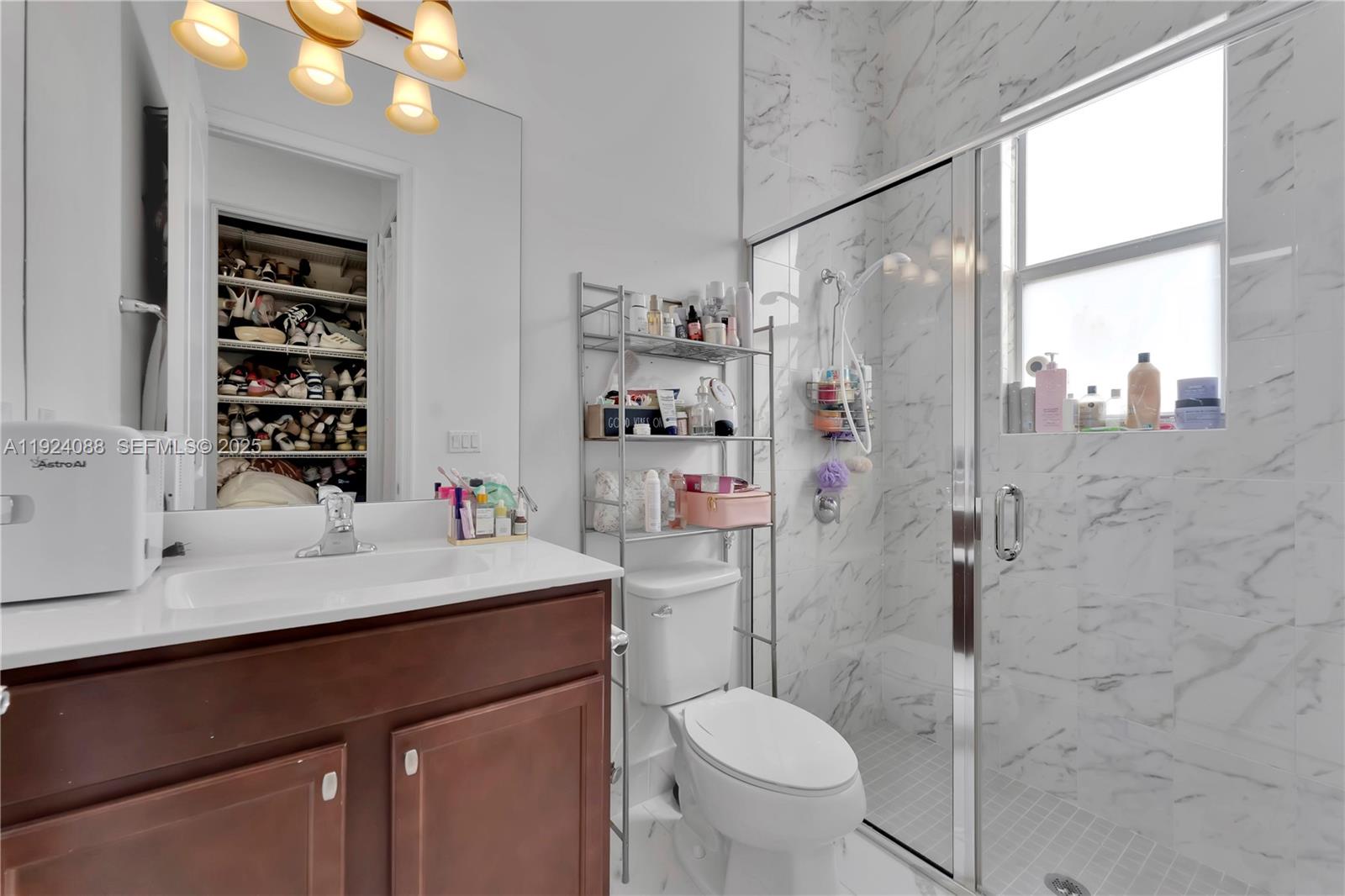 14929 Southwest 176th Terrace Miami, FL 33187 - Photo 23 of 38 a bathroom with a sink toilet and shower