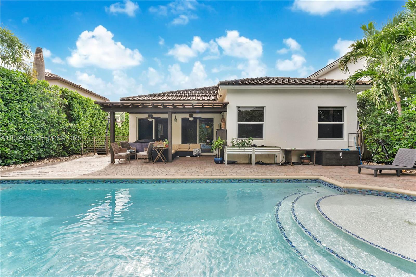 14929 Southwest 176th Terrace Miami, FL 33187 - Photo 28 of 38 a swimming pool with outdoor seating yard and barbeque oven