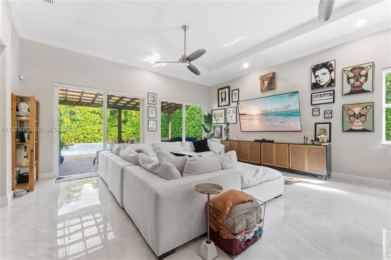 14929 Southwest 176th Terrace Miami, FL 33187 - Photo 3 of 38 a living room with furniture and a flat screen tv