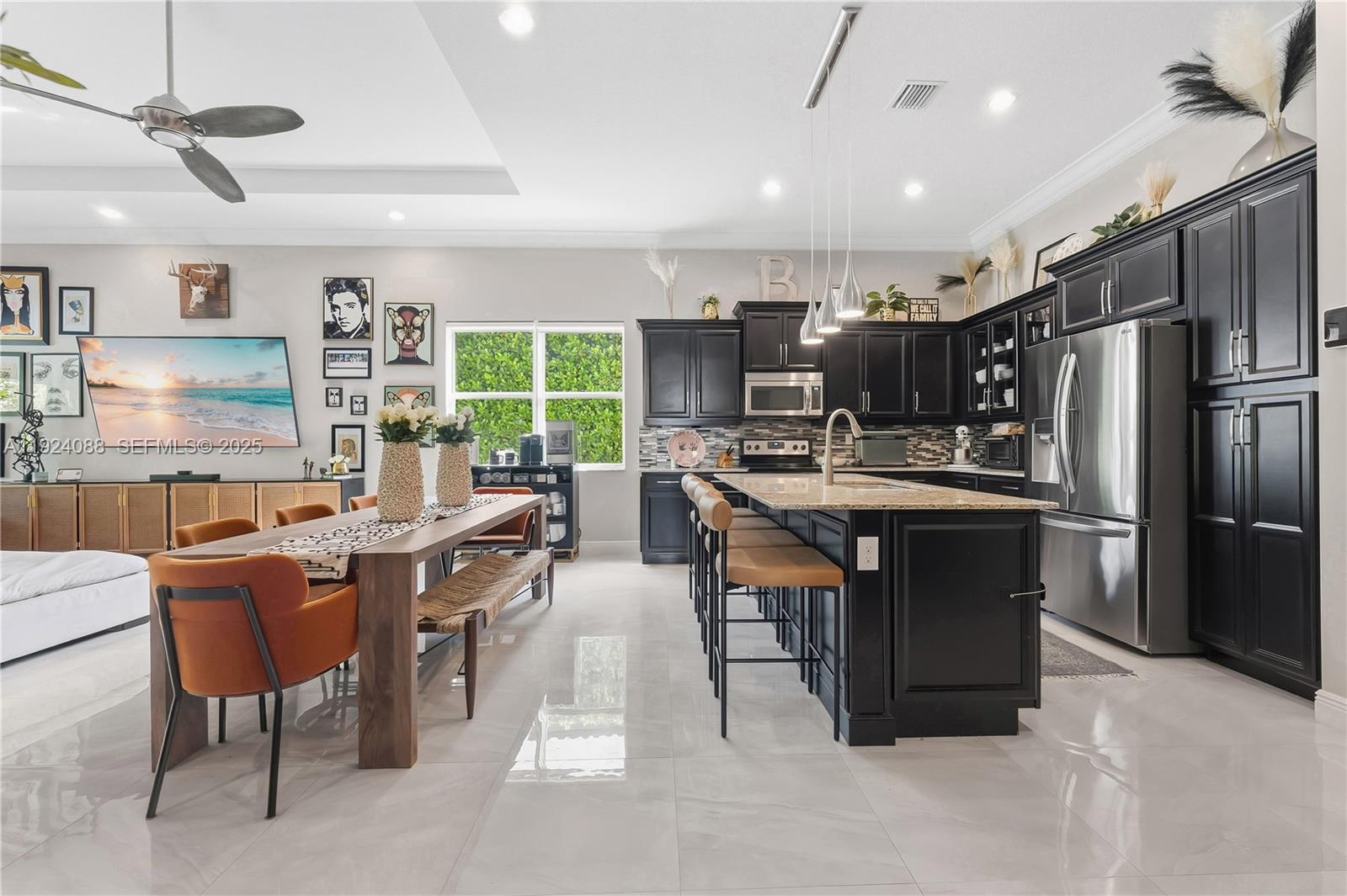 14929 Southwest 176th Terrace Miami, FL 33187 - Photo 8 of 38 a kitchen with kitchen island a dining table chairs stainless steel appliances and cabinets