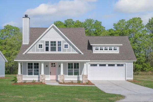 a front view of a house with a yard table and chairs