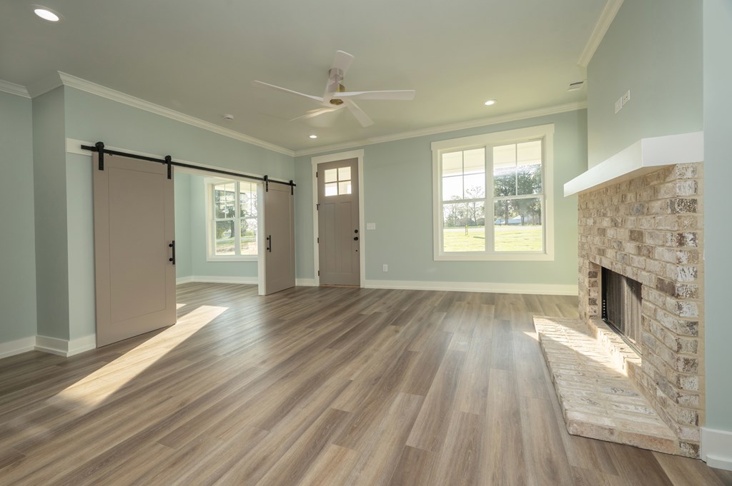 1190 Lee Road Phenix City, AL 36870 - Photo 12 of 52 a view of an empty room with wooden floor and a window