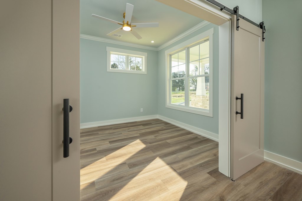 1190 Lee Road Phenix City, AL 36870 - Photo 13 of 52 a view of empty room with wooden floor and fan