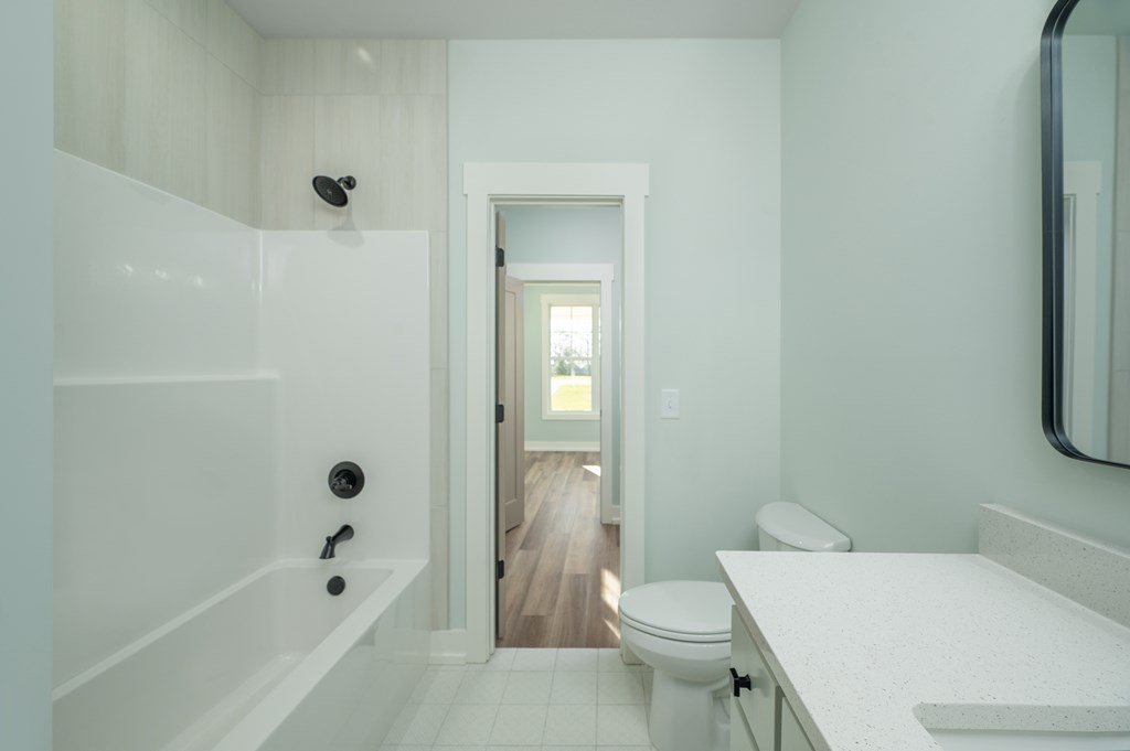 1190 Lee Road Phenix City, AL 36870 - Photo 16 of 52 a white toilet sitting next to a bath tub