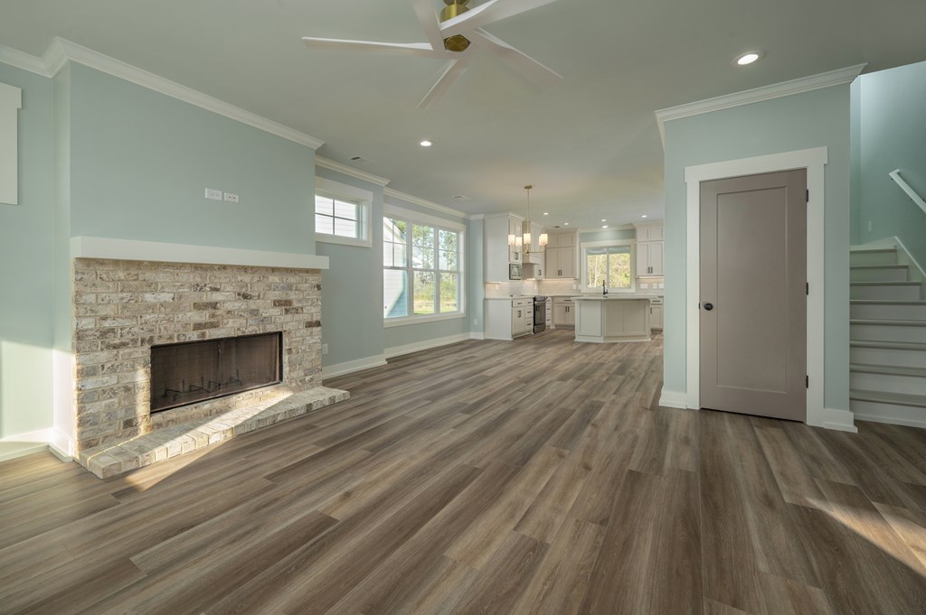 1190 Lee Road Phenix City, AL 36870 - Photo 17 of 52 wooden floor fireplace and windows in an empty room