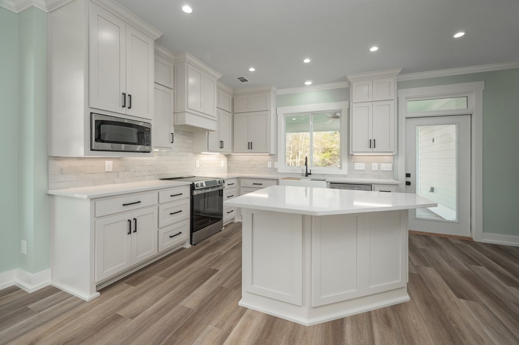1190 Lee Road Phenix City, AL 36870 - Photo 20 of 52 a kitchen with kitchen island granite countertop a sink cabinets and stainless steel appliances