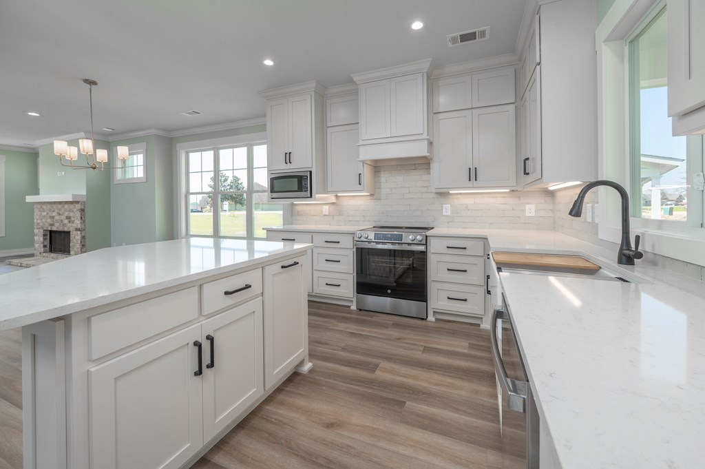 1190 Lee Road Phenix City, AL 36870 - Photo 22 of 52 a kitchen with stainless steel appliances granite countertop a stove sink and cabinets