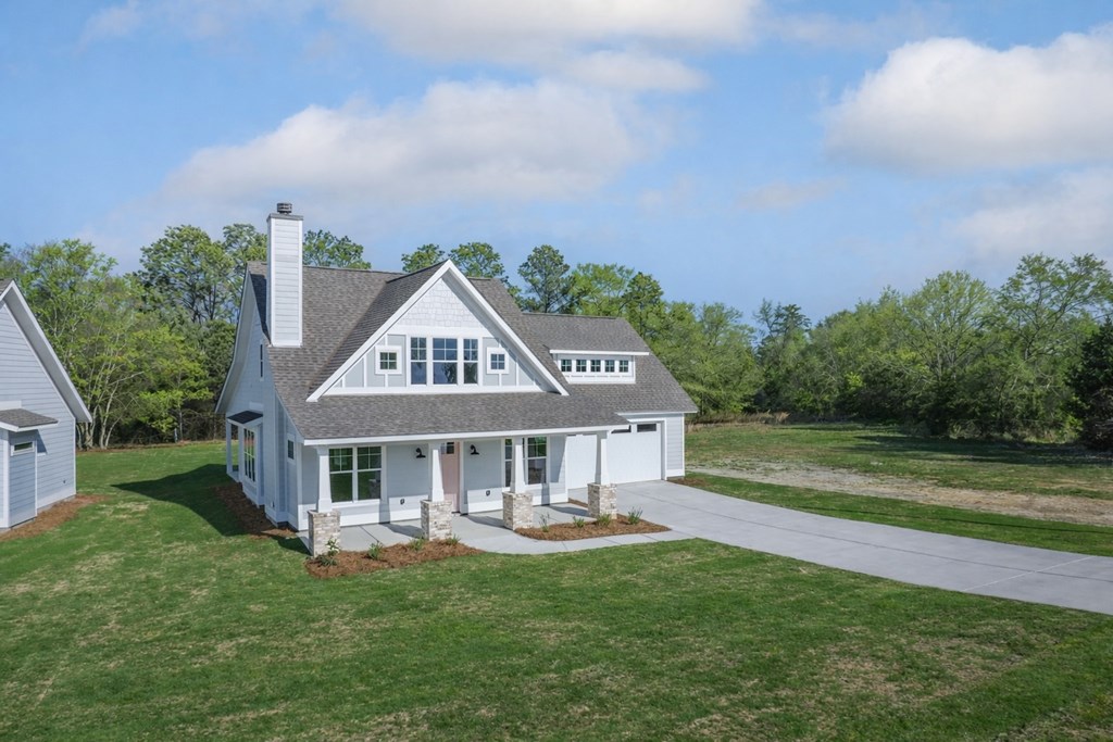 1190 Lee Road Phenix City, AL 36870 - Photo 3 of 52 a front view of a house with a garden