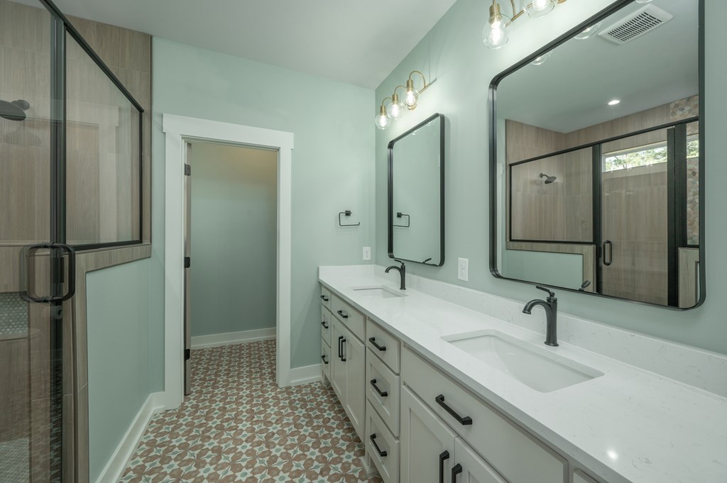1190 Lee Road Phenix City, AL 36870 - Photo 32 of 52 a bathroom with a double vanity sink and mirror