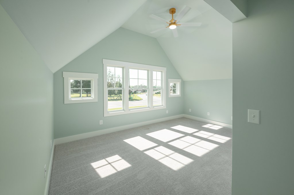 1190 Lee Road Phenix City, AL 36870 - Photo 38 of 52 an empty room with windows and chandelier fan
