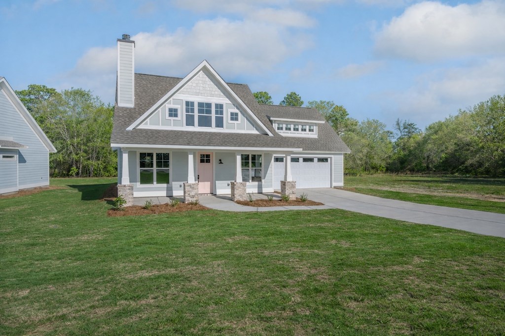 1190 Lee Road Phenix City, AL 36870 - Photo 4 of 52 a front view of a house with a garden and patio