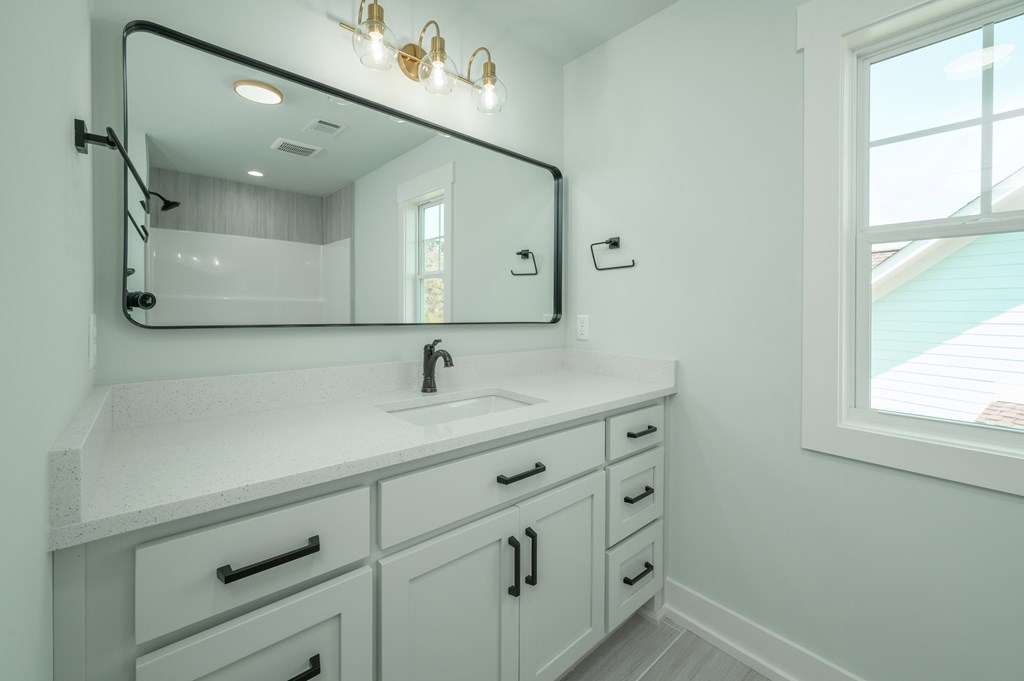 1190 Lee Road Phenix City, AL 36870 - Photo 43 of 52 a bathroom with a sink vanity and mirror