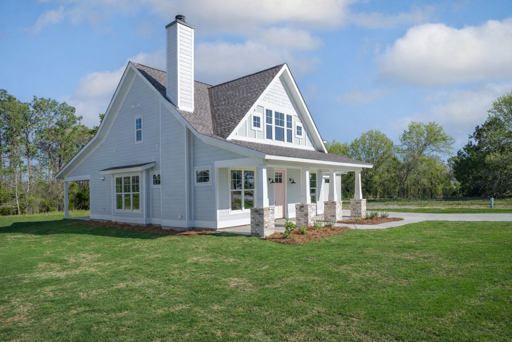 1190 Lee Road Phenix City, AL 36870 - Photo 5 of 52 a front view of a house with garden and porch