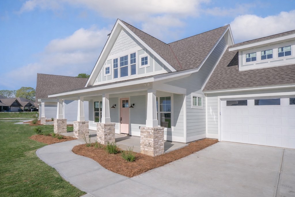 1190 Lee Road Phenix City, AL 36870 - Photo 8 of 52 a front view of a house with a yard outdoor seating and garden