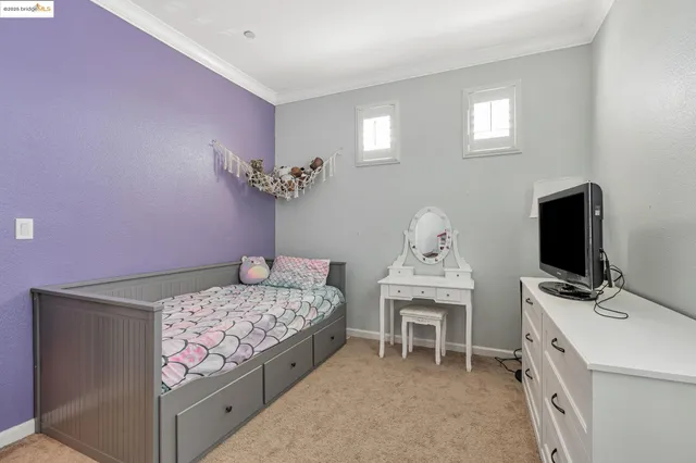 a bedroom with a bed and flat screen tv