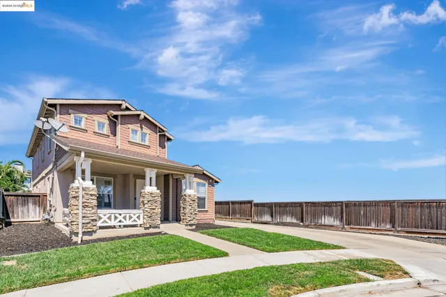 a front view of a house with a yard table and chairs