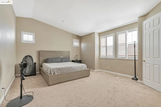 a bedroom with a bed and a lamp