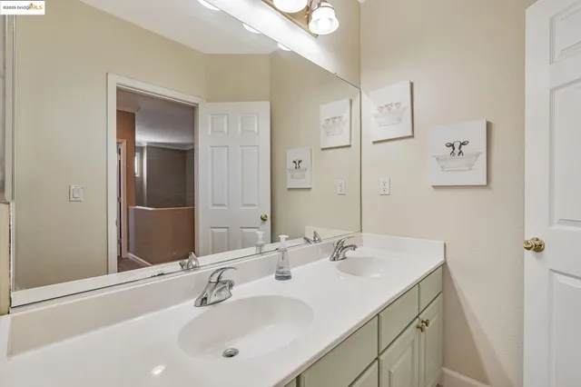 a bathroom with a granite countertop toilet sink and mirror