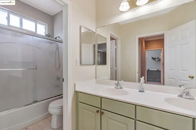 a bathroom with 2 sink and a mirror