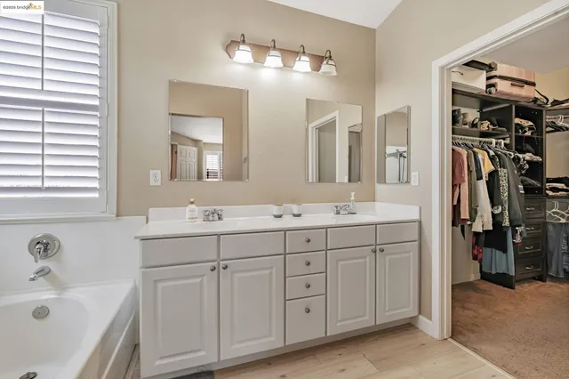 a bathroom with a double vanity sink toilet and shower