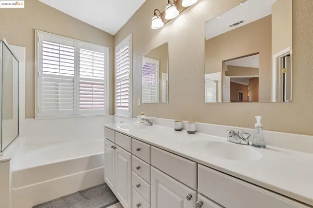 a bathroom with a tub sink and shower
