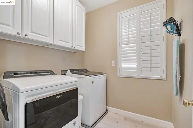 a bathroom with a tub a sink and a window
