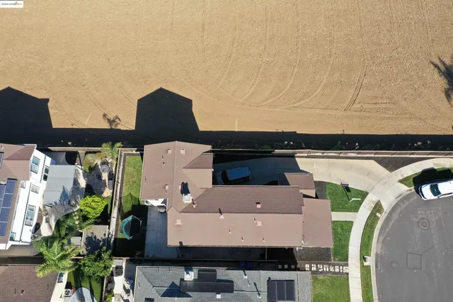 an aerial view of a house with outdoor space and parking