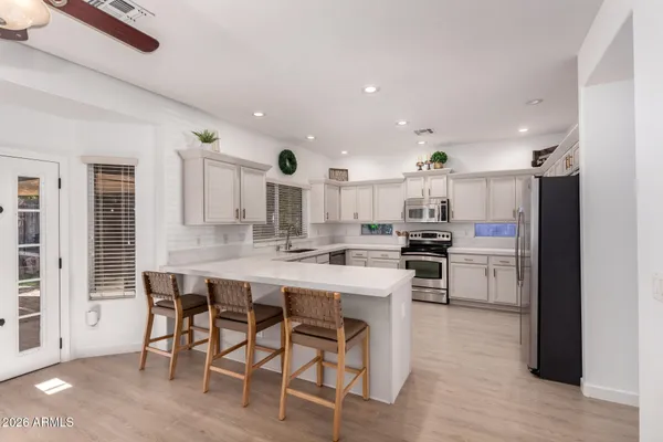 a kitchen with stainless steel appliances kitchen island granite countertop a sink and cabinets