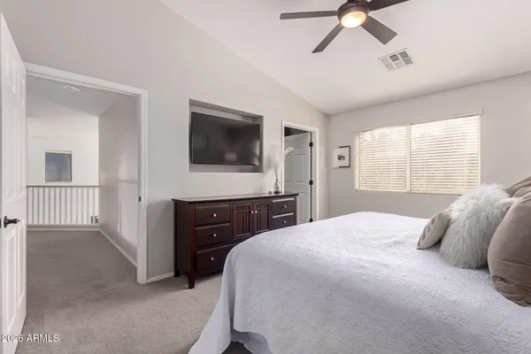 a bedroom with a bed and a flat screen tv