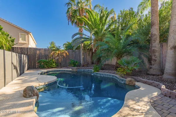 a swimming pool with outdoor seating and yard
