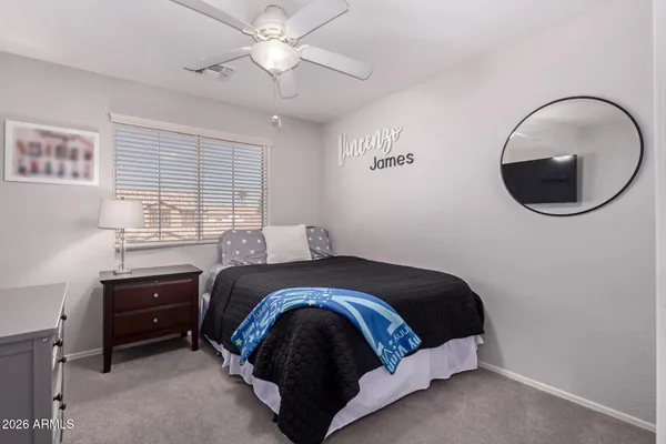 a bedroom with a bed and a mirror