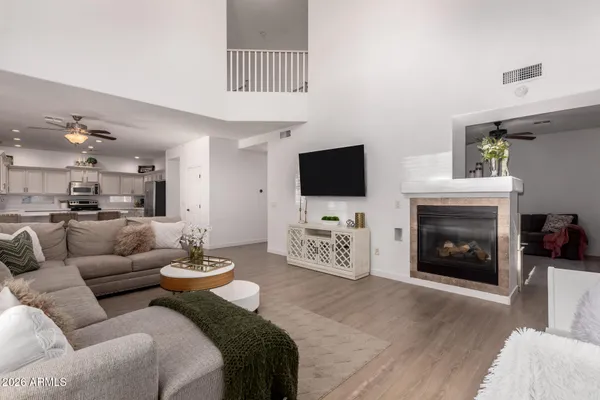 a living room with furniture a fireplace and a flat screen tv