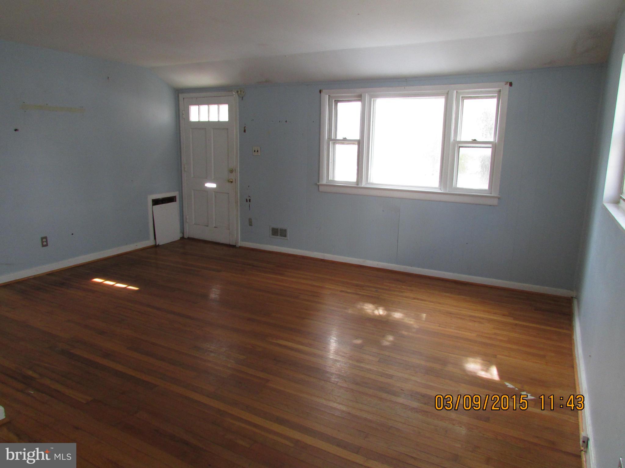 3103 Weller Road Silver Spring, MD 20906 - Photo 2 of 13 a view of an empty room with wooden floor and a window