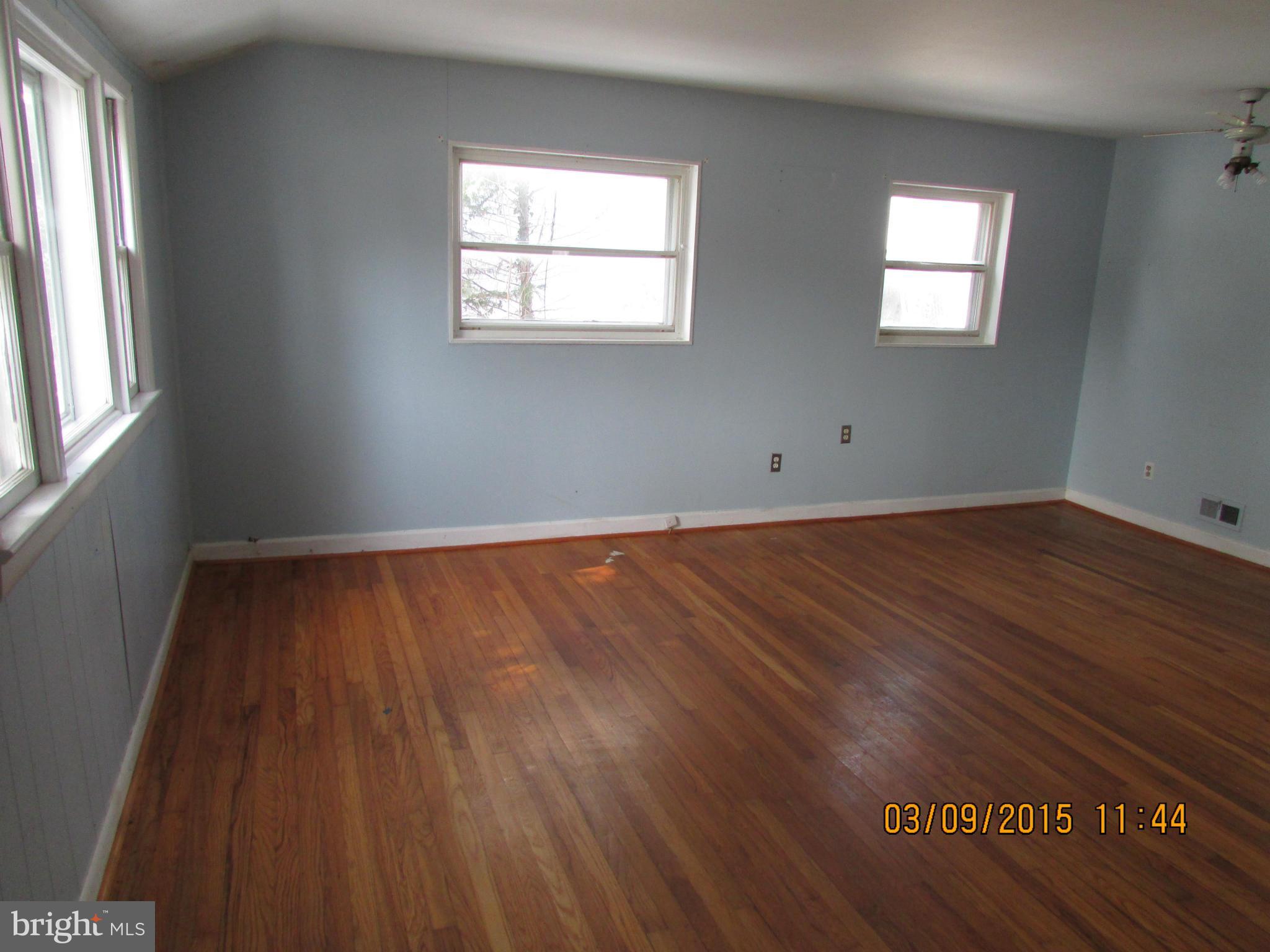 3103 Weller Road Silver Spring, MD 20906 - Photo 3 of 13 an empty room with wooden floor and windows