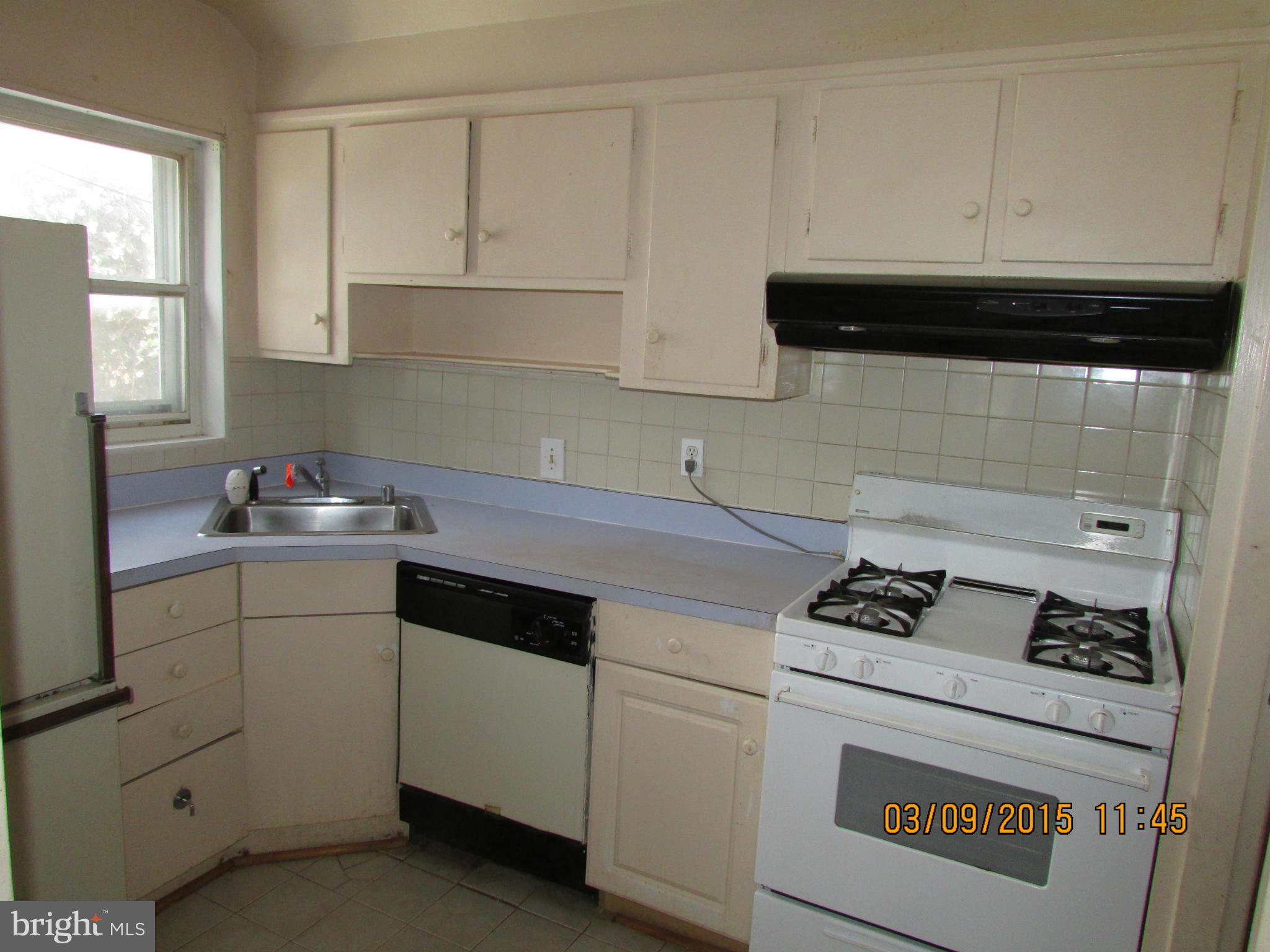 3103 Weller Road Silver Spring, MD 20906 - Photo 5 of 13 a kitchen with white cabinets and appliances
