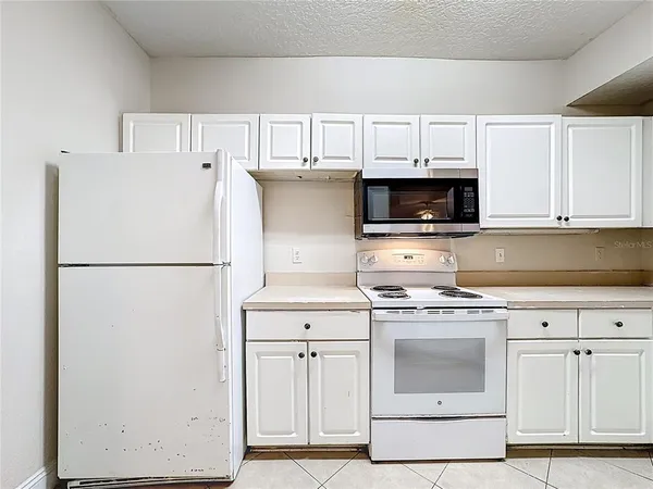 a kitchen with cabinets stainless steel appliances and a sink