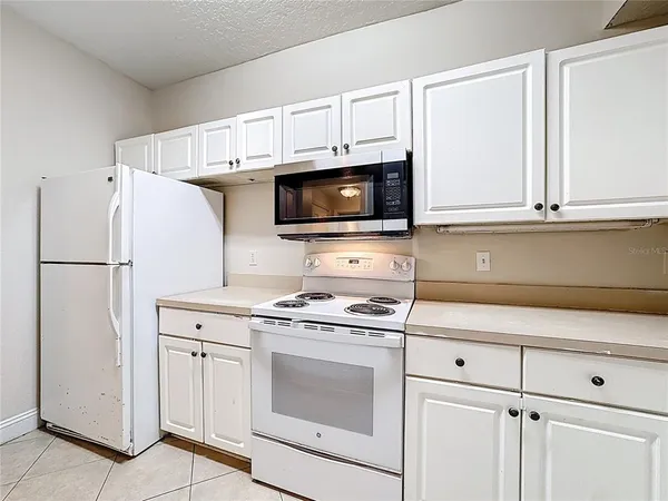 a kitchen with a stove and a microwave