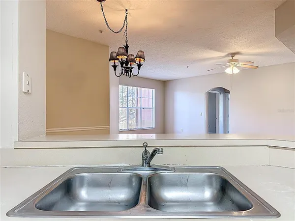 a view of a room with a wooden floor and a chandelier