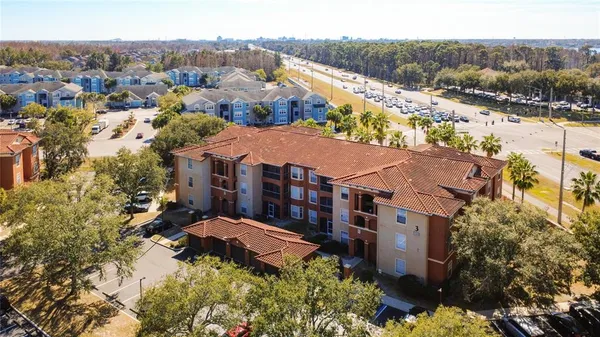 an aerial view of multiple houses with a yard