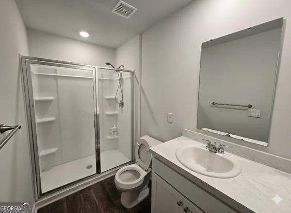 a bathroom with a sink toilet and shower