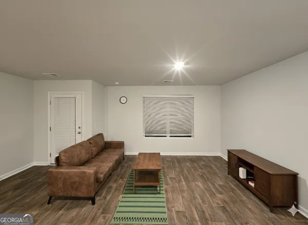 a living room with a couch and a night stand