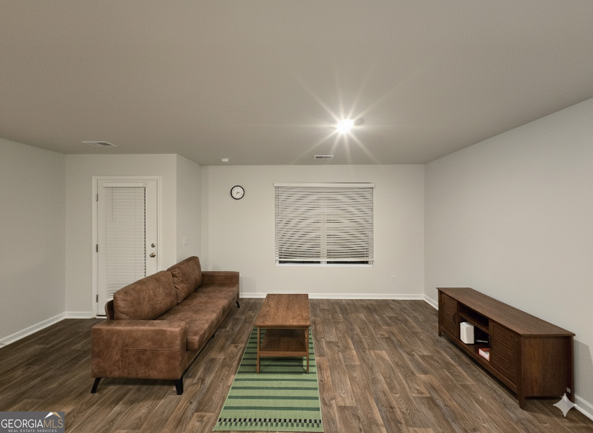 172 Coneflower Road Bloomingdale, GA 31302 - Photo 4 of 10 a living room with a couch and a night stand