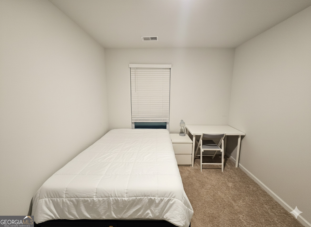 172 Coneflower Road Bloomingdale, GA 31302 - Photo 8 of 10 a bedroom with a bed and chair