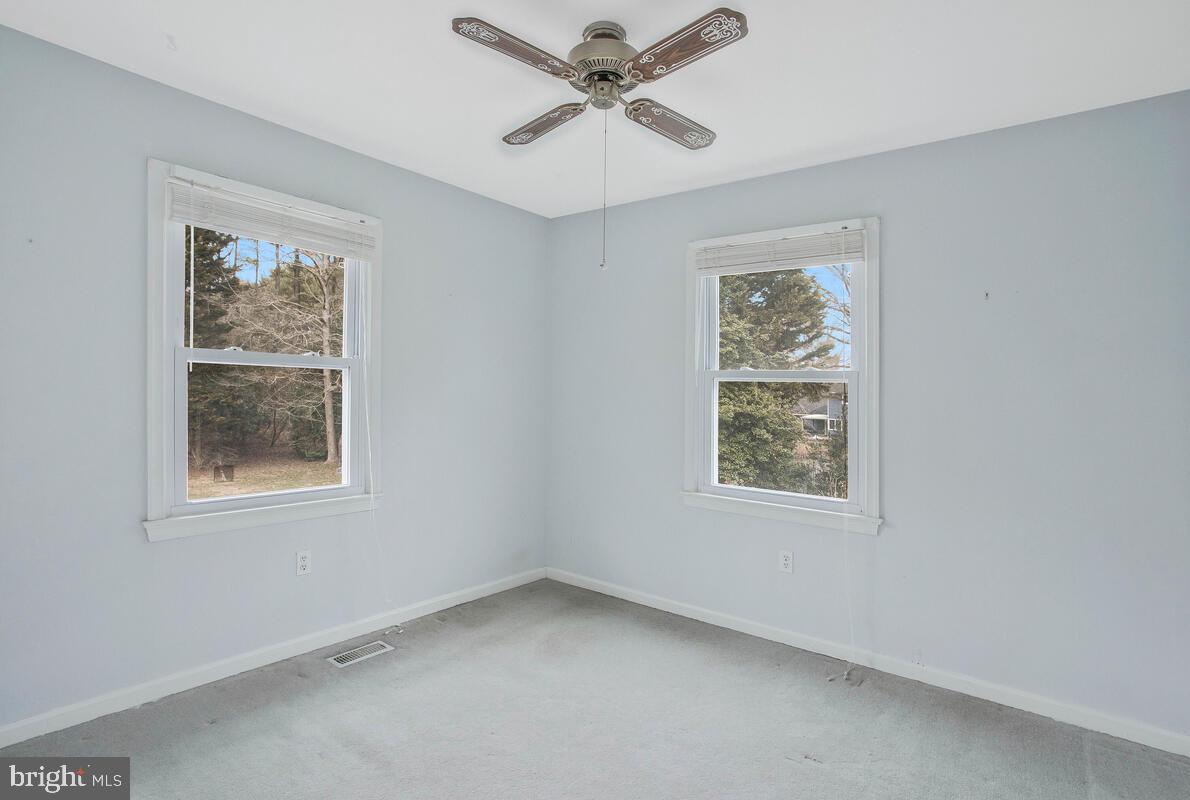 6155 Sandy Point Road Prince Frederick, MD 20678 - Photo 22 of 50 an empty room with a window and a ceiling fan