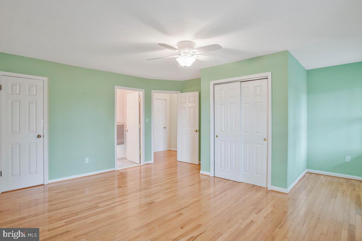 6155 Sandy Point Road Prince Frederick, MD 20678 - Photo 26 of 50 an empty room with wooden floor and windows